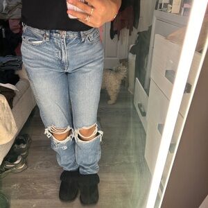 Mom jean, Regular, Super high rise Light wash blue jeans with rips on the knees.